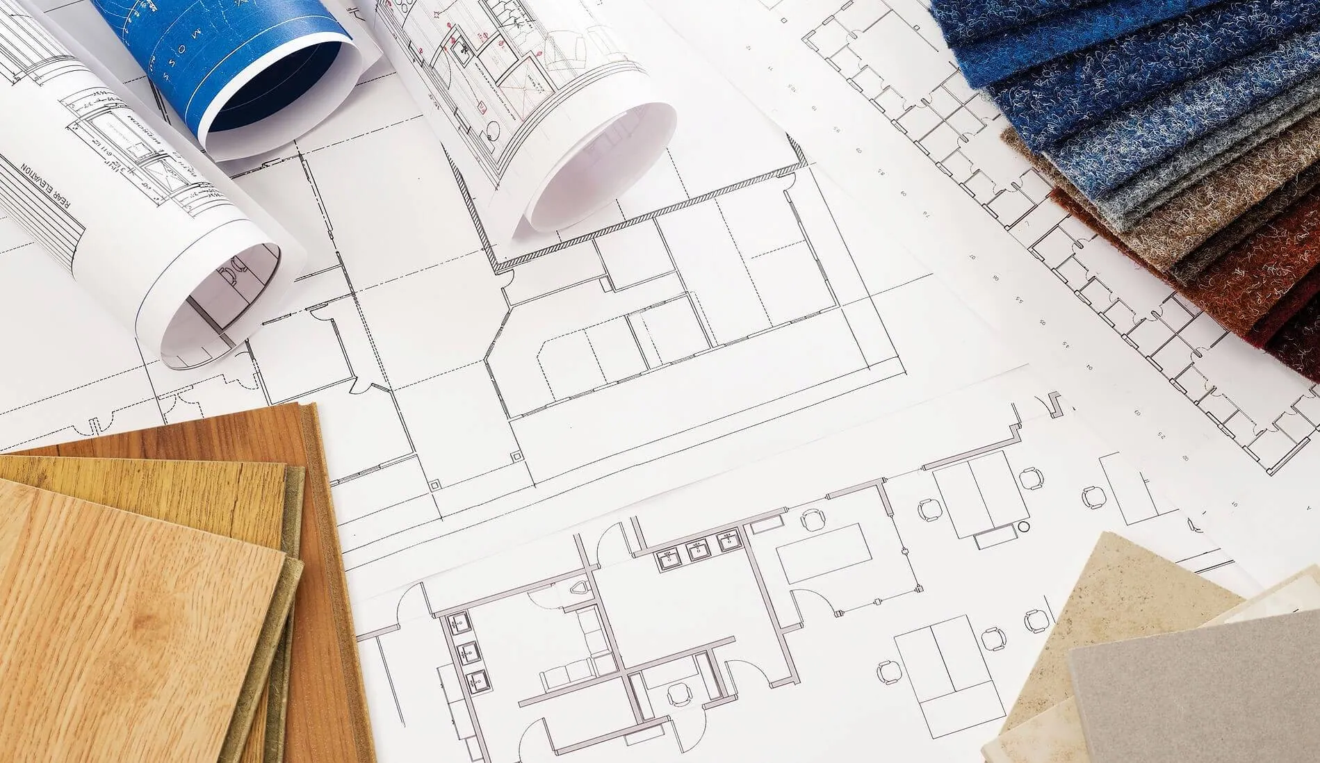 Construction blueprints, floor plans, and material samples used for quantity takeoff